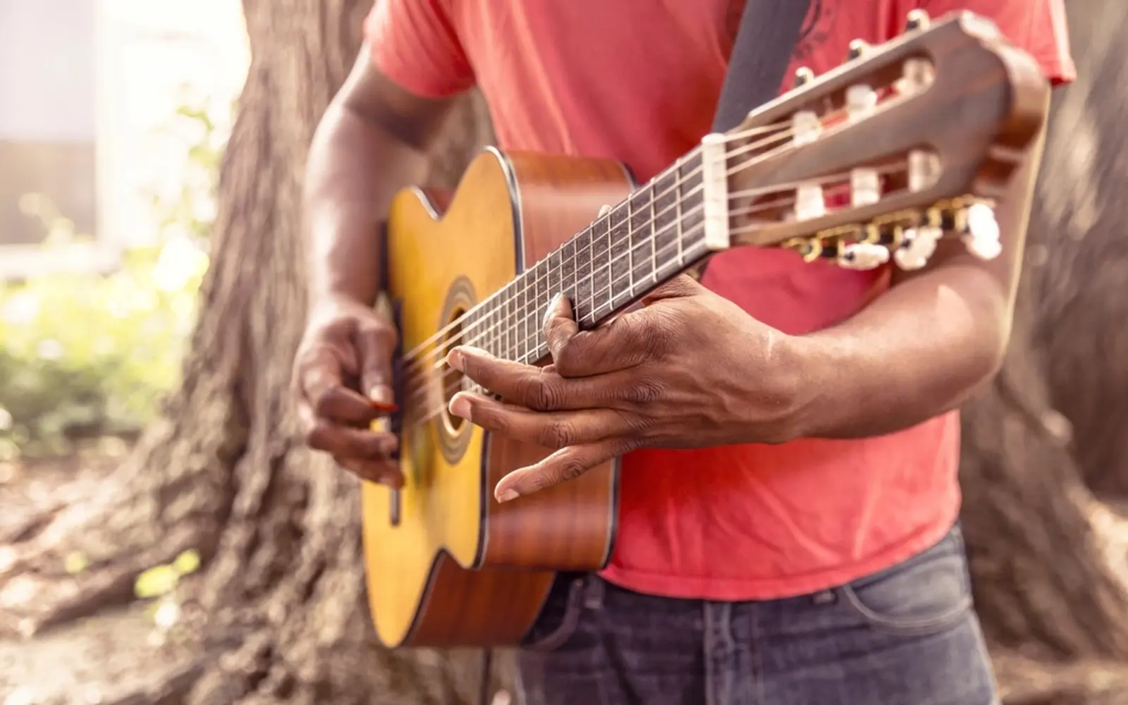 A person playing an acoustic guitar